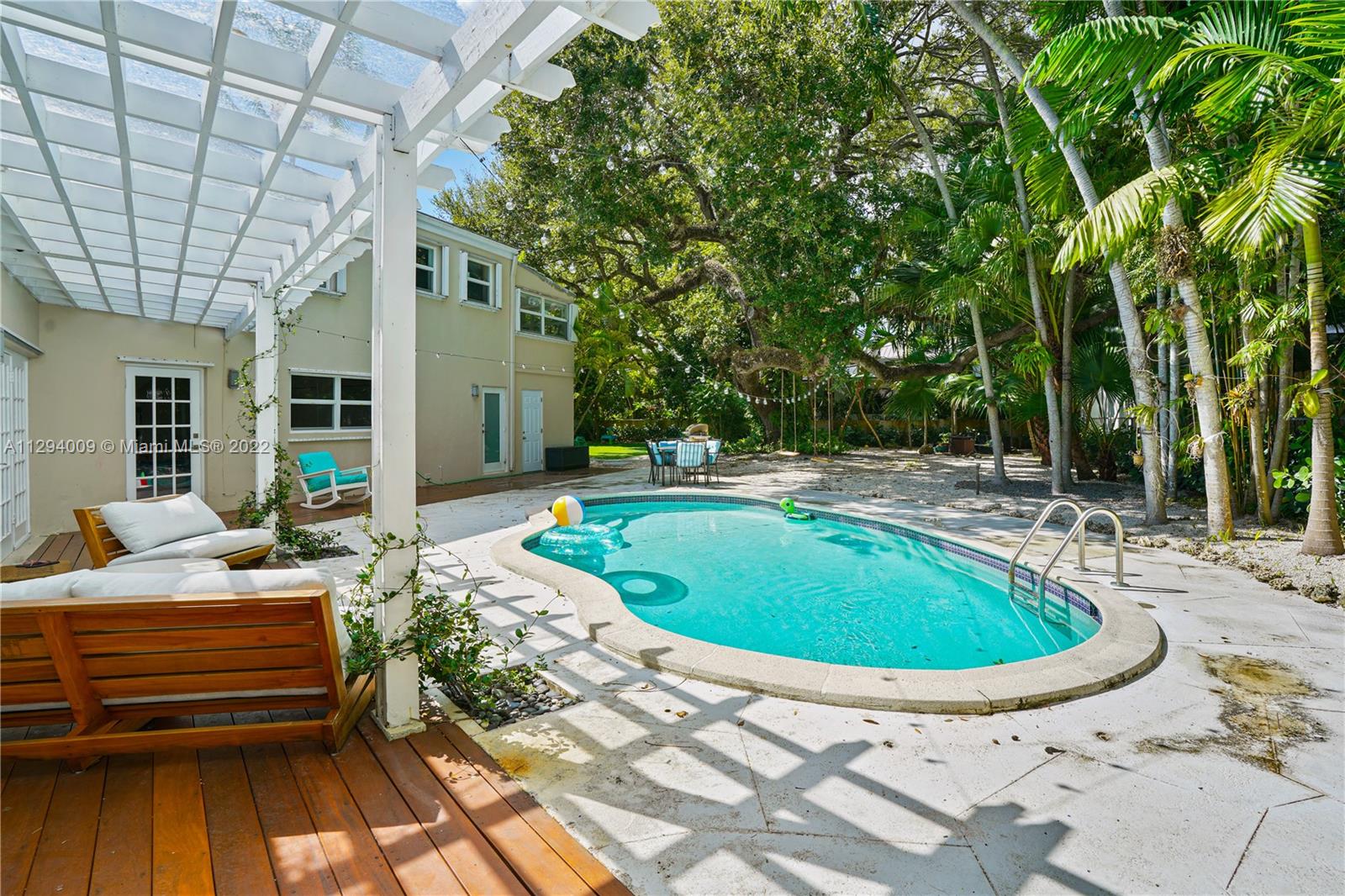 1701 Micanopy Avenue Miami, FL 33133 - Photo 35 of 46 a swimming pool with outdoor seating and yard