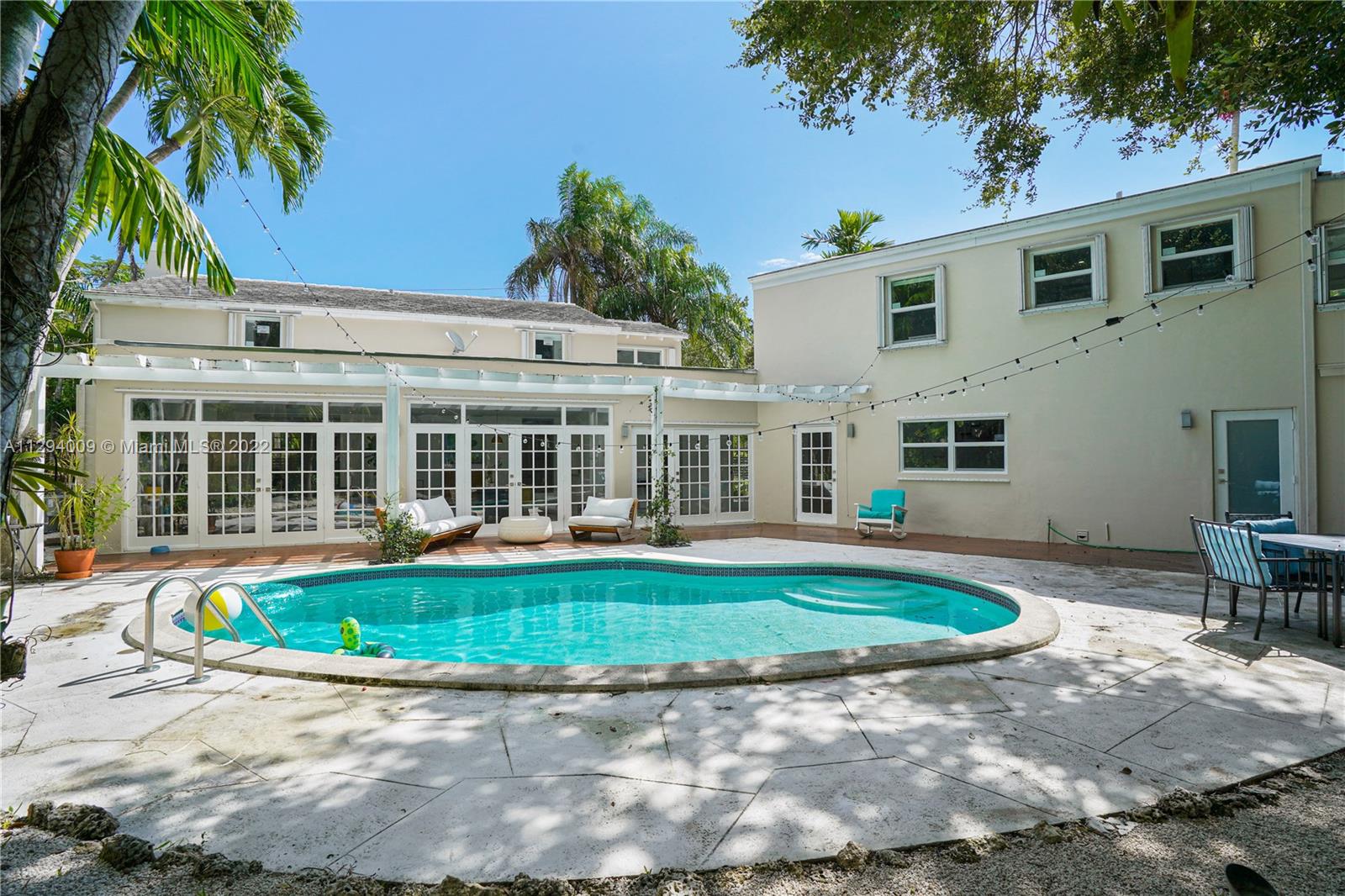 1701 Micanopy Avenue Miami, FL 33133 - Photo 36 of 46 a front view of a house with swimming pool having outdoor seating