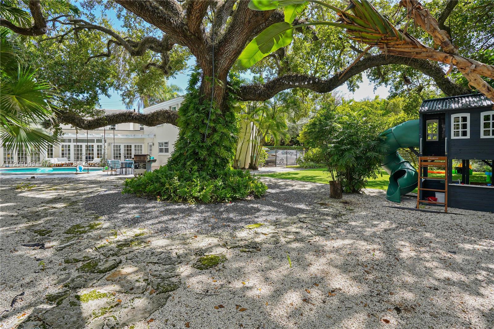 1701 Micanopy Avenue Miami, FL 33133 - Photo 37 of 46 a view of a yard with plants and trees
