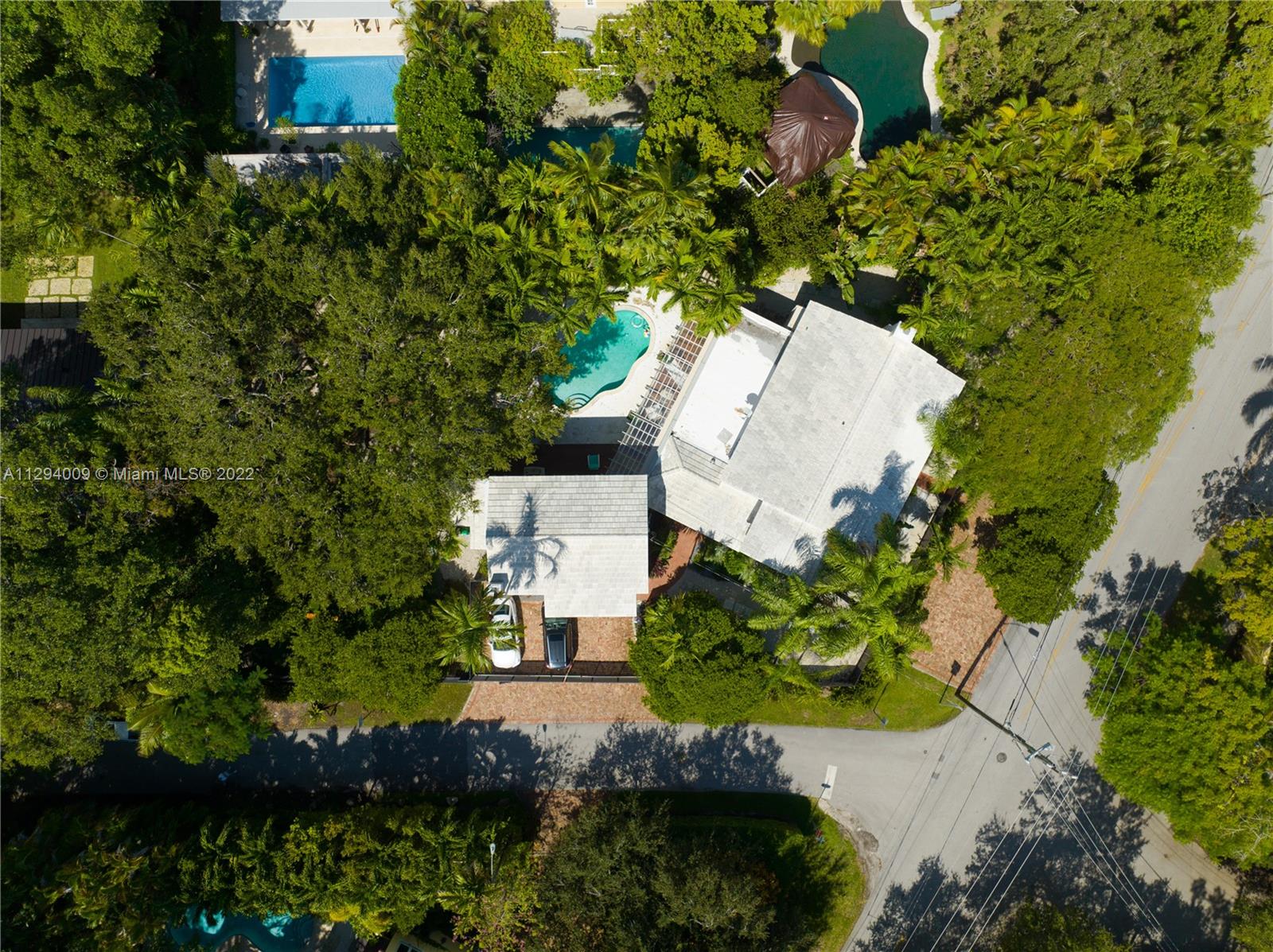 1701 Micanopy Avenue Miami, FL 33133 - Photo 44 of 46 an aerial view of a house with a yard and trees