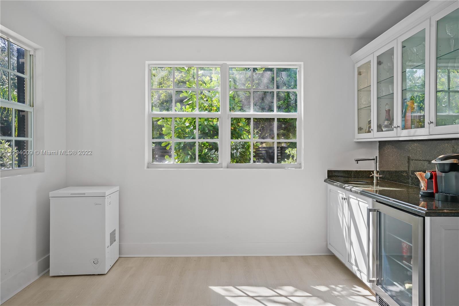 1701 Micanopy Avenue Miami, FL 33133 - Photo 9 of 46 a kitchen with granite countertop a stove a sink and a window