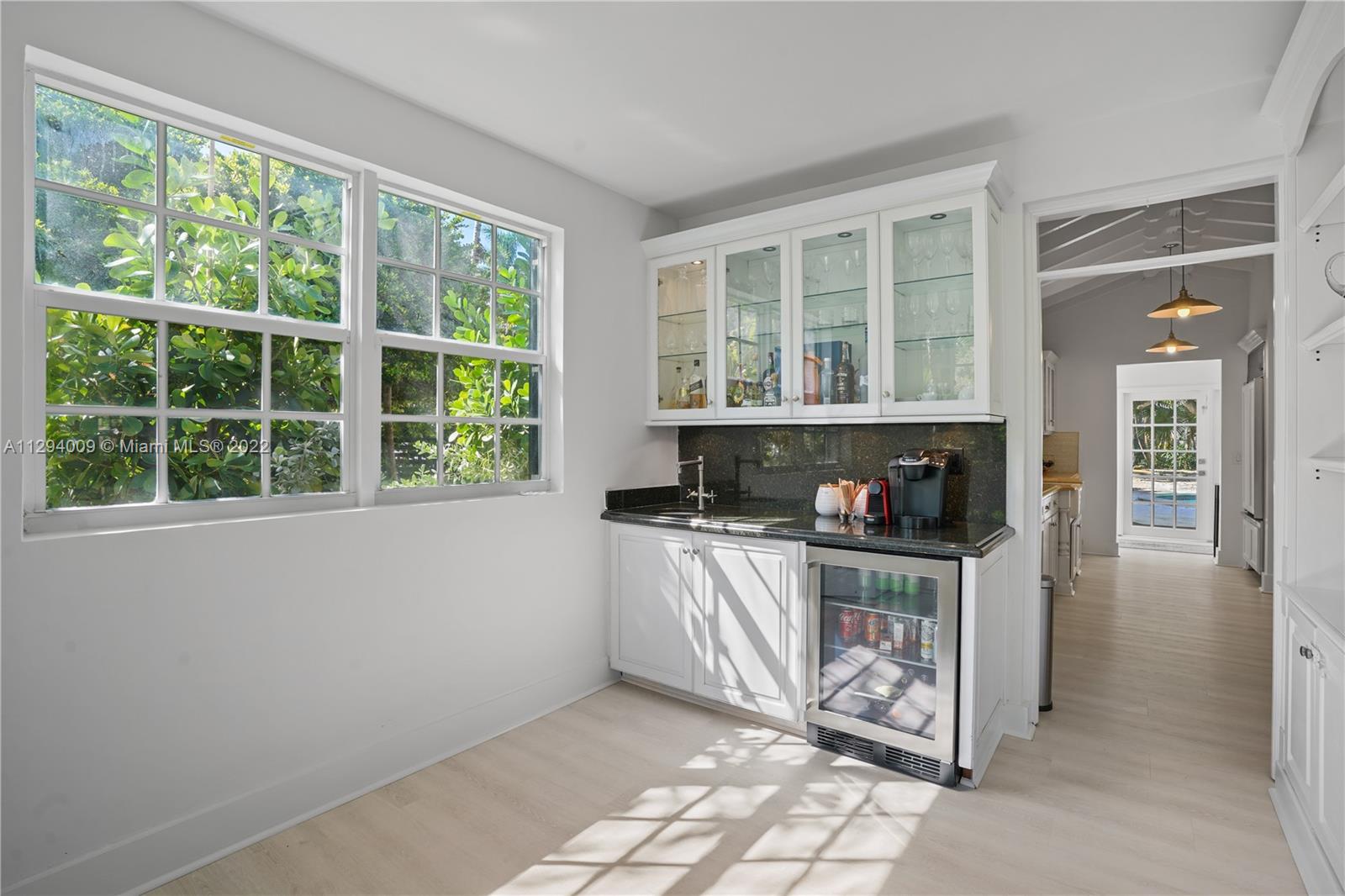 1701 Micanopy Avenue Miami, FL 33133 - Photo 10 of 46 a kitchen with a stove a sink and a microwave
