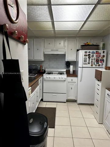 a kitchen with a stove a refrigerator and a sink