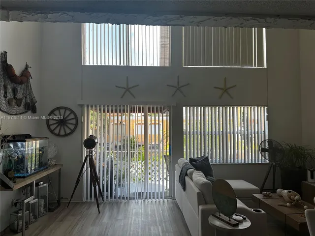 a view of a livingroom with furniture and hardwood floor