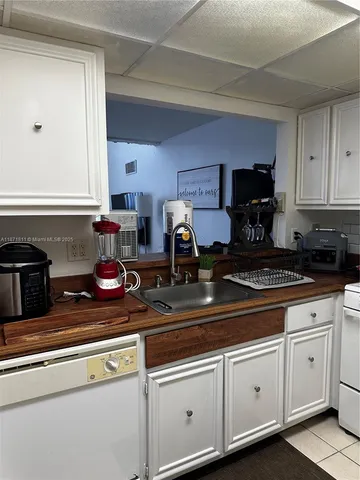 a kitchen with a stove and white cabinets