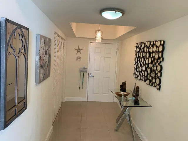 a bedroom with a bed and a tv on dresser