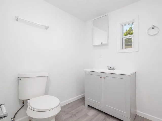 a white toilet sitting next to a bathroom sink