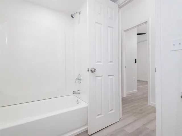 a bathroom with a tub and shower