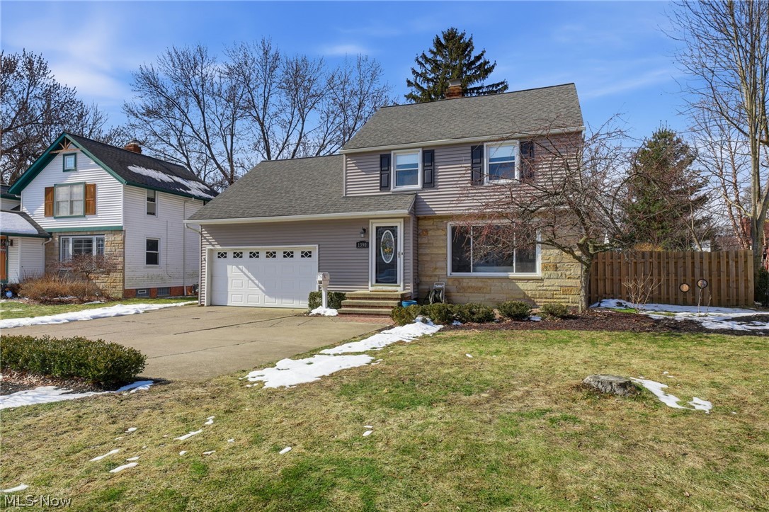 1390 Brainard Road Lyndhurst, OH 44124 - Photo 2 of 33 Traditional home with an attached garage, roof with shingles, concrete driveway, stone siding, and a chimney