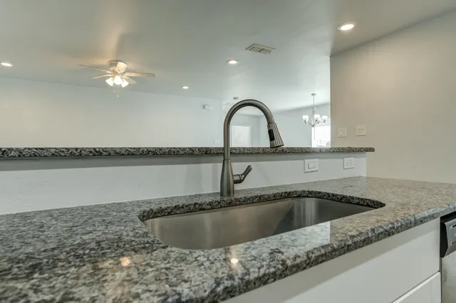 a view of a kitchen counter a sink and cabinets