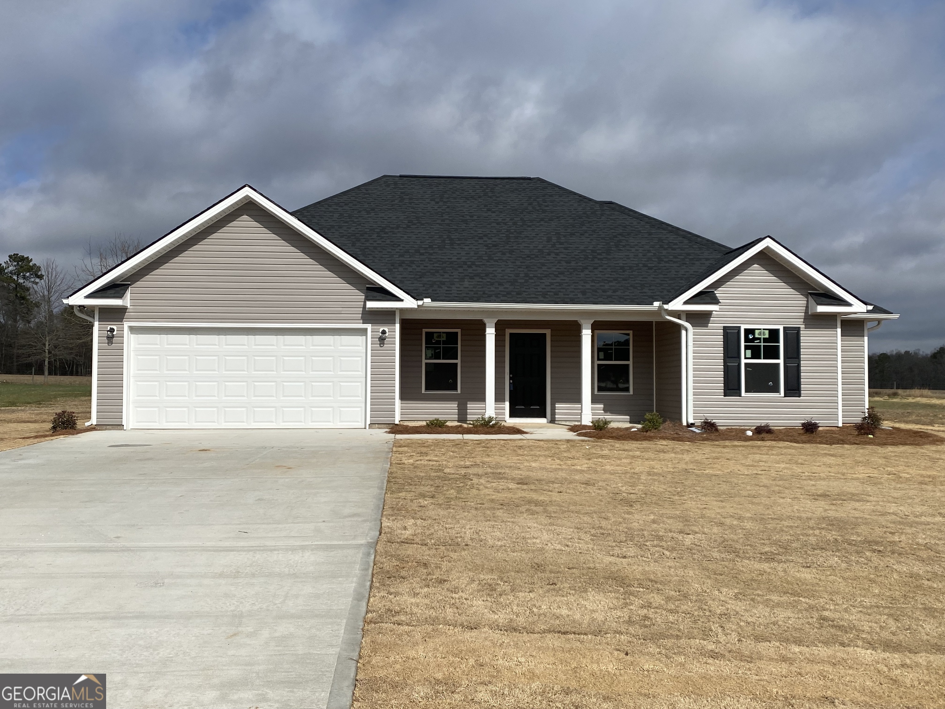 144 Mathews Road Milner, GA 30257 - Photo 1 of 1 a front view of a house with a yard and garage