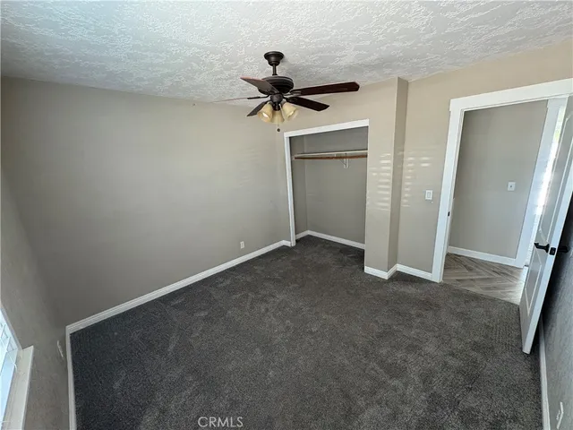 a view of a room with a ceiling fan