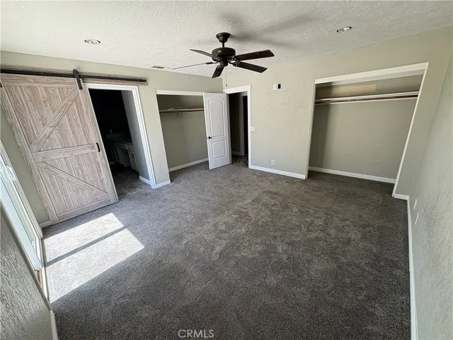 a view of empty room with ceiling fan
