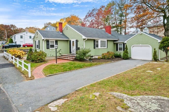 a front view of a house with a yard and garage