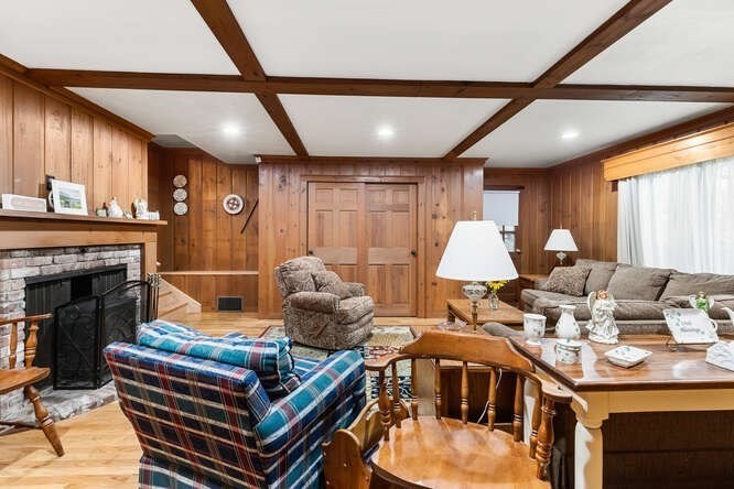 115 Quinn Road Lynn, MA 01904 - Photo 18 of 38 a living room with furniture a fireplace and a large window