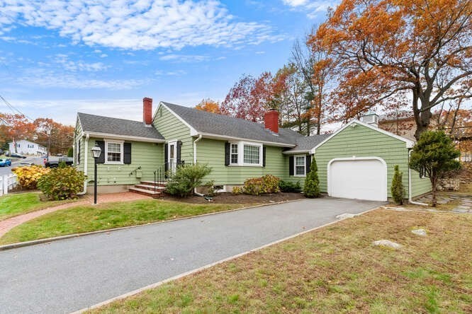 115 Quinn Road Lynn, MA 01904 - Photo 31 of 38 a front view of a house with a garden and trees