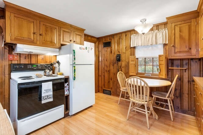 115 Quinn Road Lynn, MA 01904 - Photo 7 of 38 a kitchen with stainless steel appliances a stove a refrigerator a dining table and chairs