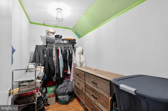 a view of walk in closet with clothes