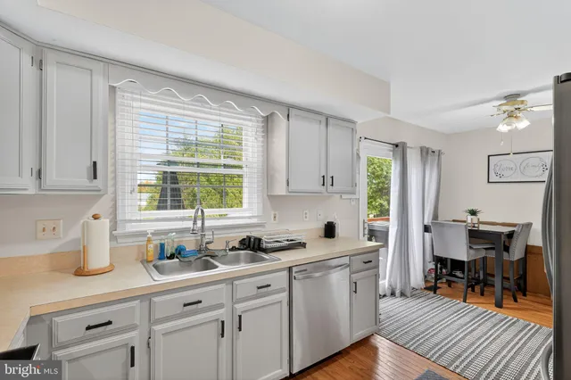 a kitchen with sink cabinets and window