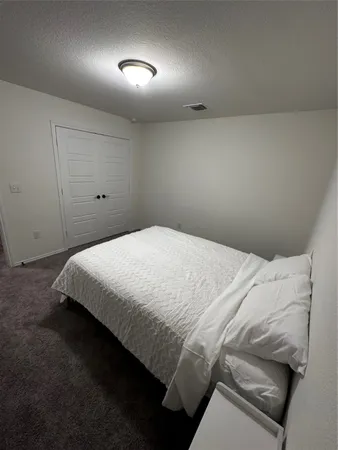 a bed sitting in a room next to a window