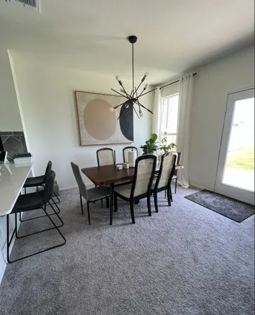 a dining room with furniture and window