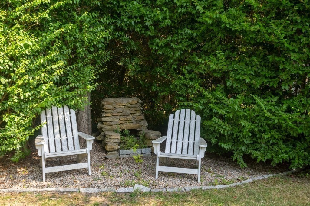 91 Balsam Street Fairhaven, MA 02719 - Photo 15 of 39 a view of a wooden bench and chair in the backyard