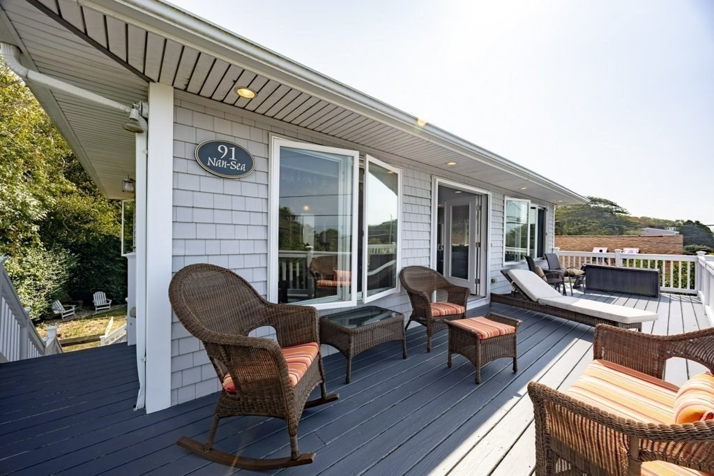 91 Balsam Street Fairhaven, MA 02719 - Photo 22 of 39 a balcony with furniture and a fireplace