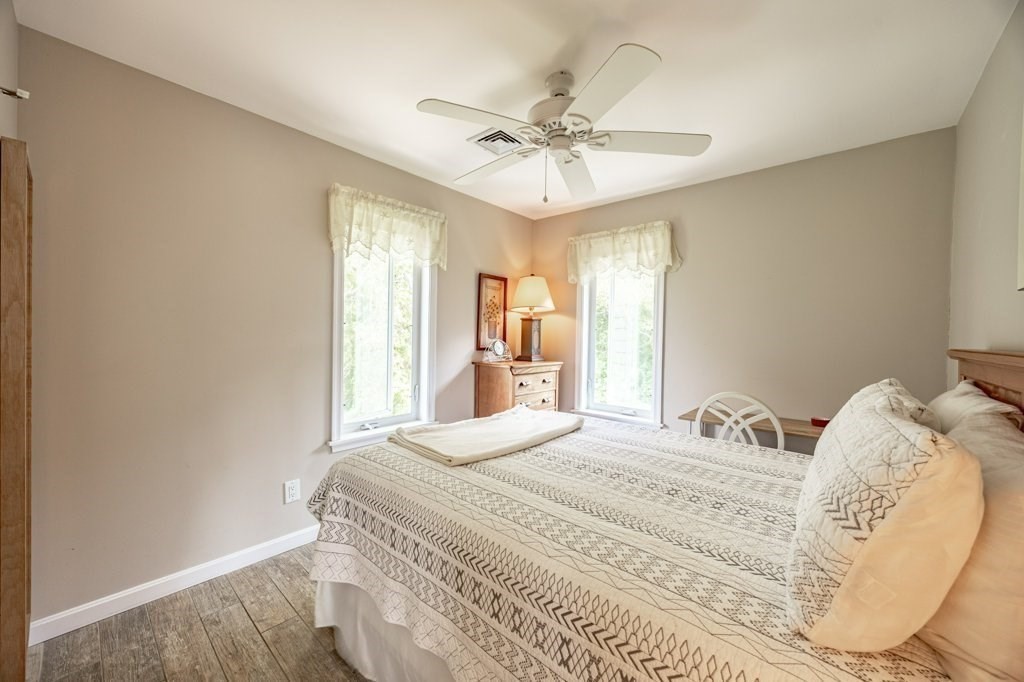 91 Balsam Street Fairhaven, MA 02719 - Photo 24 of 39 a bedroom with a large bed and a chandelier