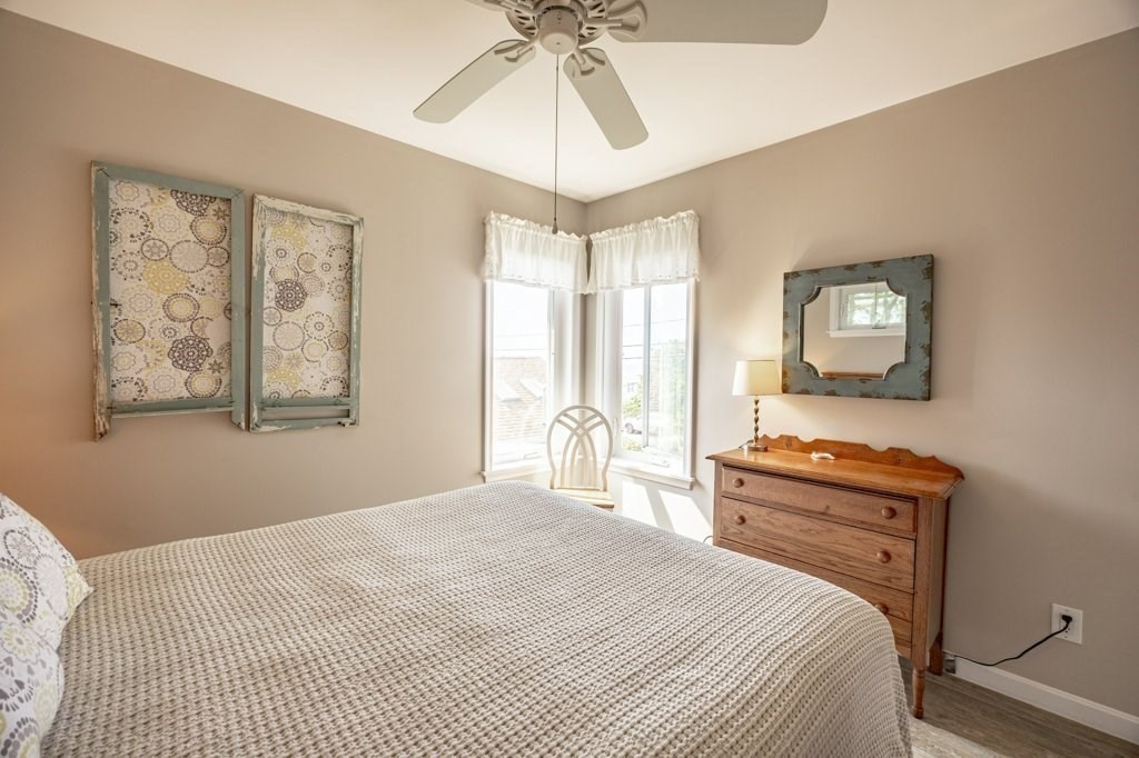 91 Balsam Street Fairhaven, MA 02719 - Photo 27 of 39 a bedroom with a bed and a chandelier