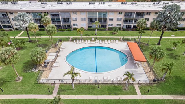 a view of swimming pool with outdoor seating and yard