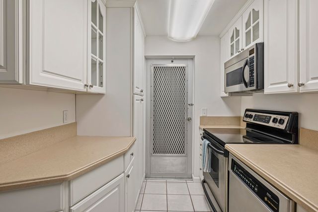 a kitchen with stainless steel appliances granite countertop a sink and a stove