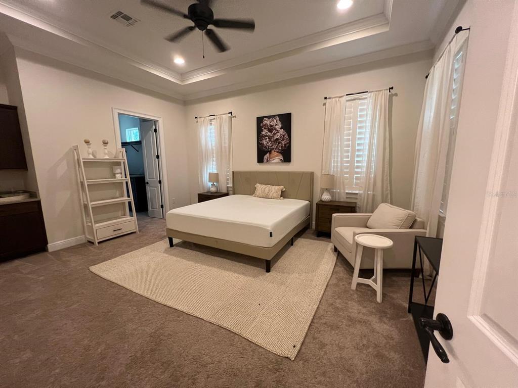 12927 Canopy Woods Way Winter Garden, FL 34787 - Photo 14 of 41 a bedroom with a bed and a table