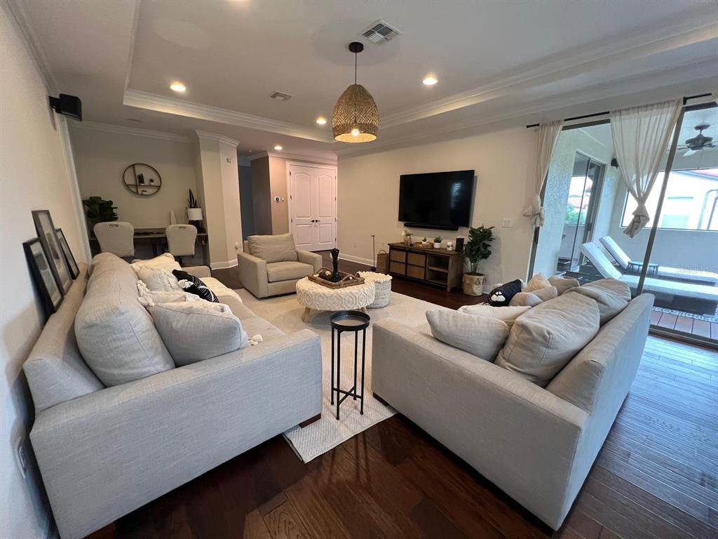 12927 Canopy Woods Way Winter Garden, FL 34787 - Photo 18 of 41 a living room with furniture and a flat screen tv