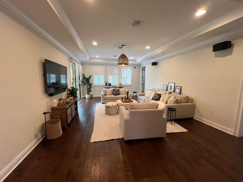 12927 Canopy Woods Way Winter Garden, FL 34787 - Photo 19 of 41 a living room with fireplace furniture and a flat screen tv