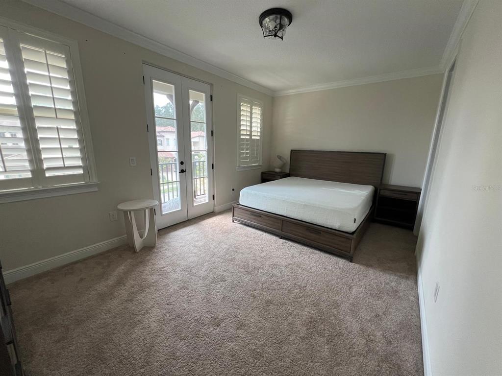 12927 Canopy Woods Way Winter Garden, FL 34787 - Photo 26 of 41 a spacious bedroom with a bed and window