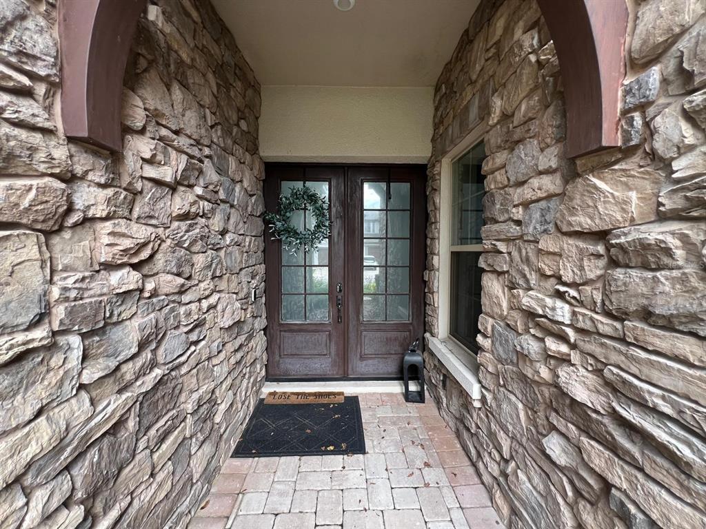 12927 Canopy Woods Way Winter Garden, FL 34787 - Photo 4 of 41 a view of a pathway door of the house