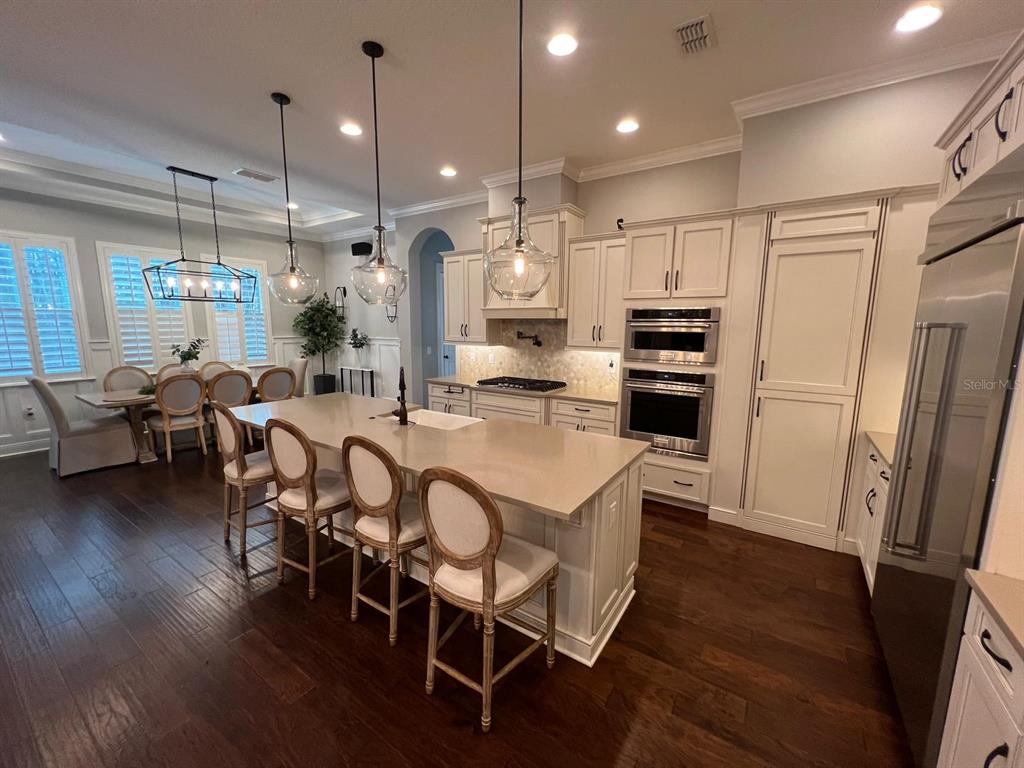 12927 Canopy Woods Way Winter Garden, FL 34787 - Photo 9 of 41 a large kitchen with a table and chairs