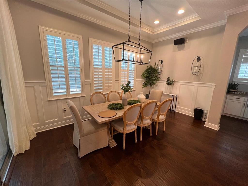 12927 Canopy Woods Way Winter Garden, FL 34787 - Photo 10 of 41 a view of a dining room with furniture and wooden floor