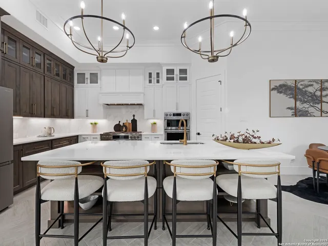 a kitchen with a dining table and chairs