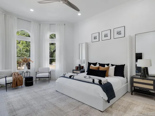 a bedroom with a bed and glass window