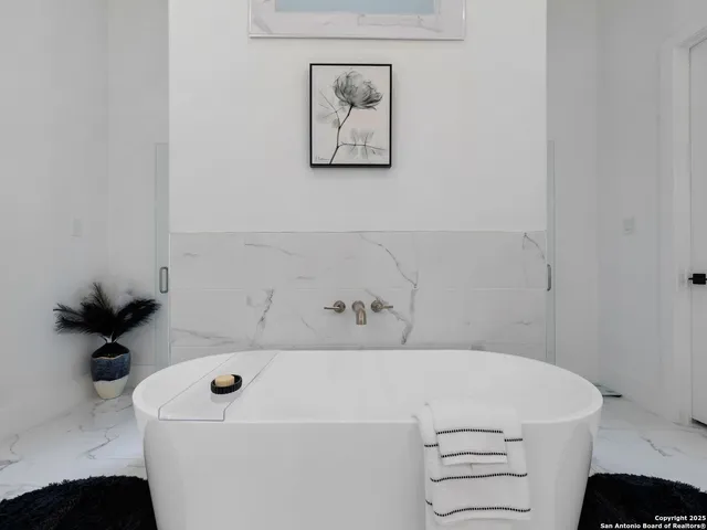 a bathroom with a white sink and a bathtub