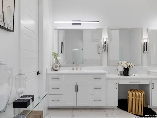 a spacious bathroom with a granite countertop sink a mirror and shower