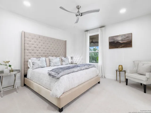 a bedroom with a bed couch and window