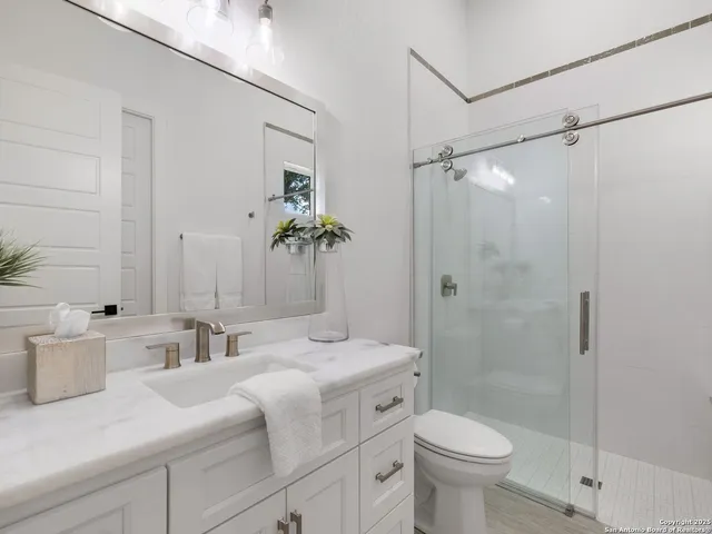 a bathroom with a sink toilet and shower