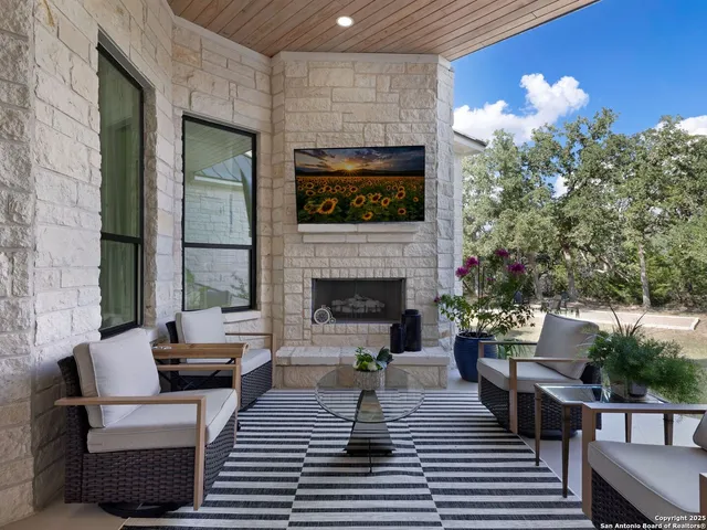 a living room with furniture a fireplace and a potted plant