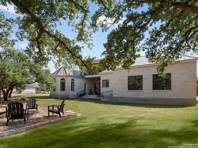 a view of a house with a backyard porch and sitting area
