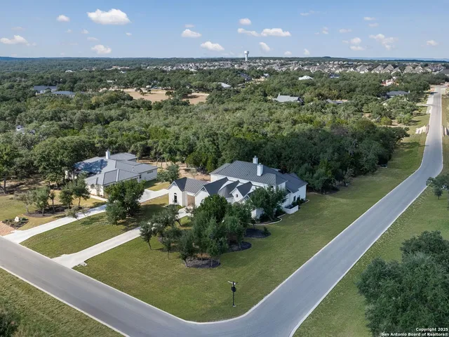 an aerial view of a house with a garden and mountain view