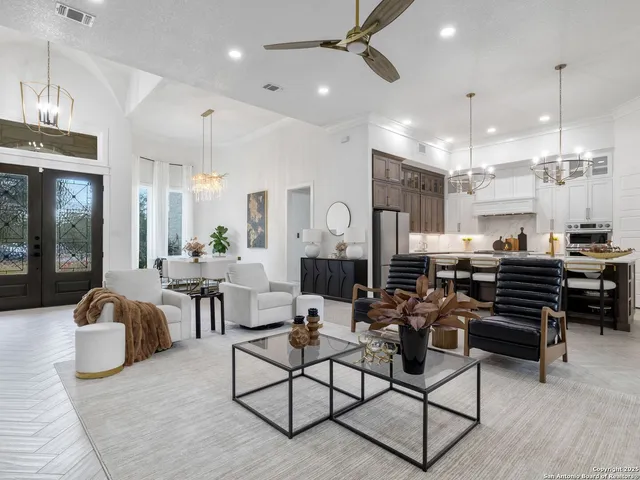 a living room with lots of furniture and a chandelier