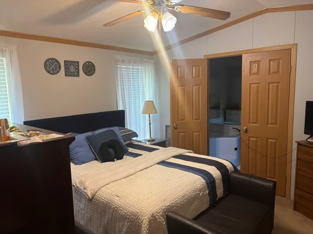 a bedroom with a bed and a chandelier