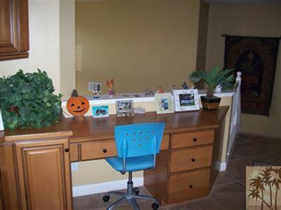 37454 Haweswater Road Indio, CA 92203 - Photo 12 of 25 a room with a desk chair and a chandelier